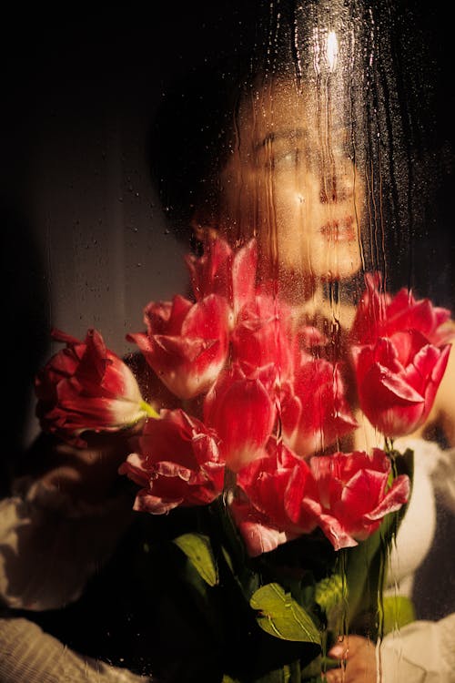 Woman with Flowers behind Glass