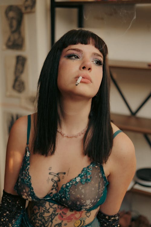 Portrait of Tattooed Woman Smoking Cigarette