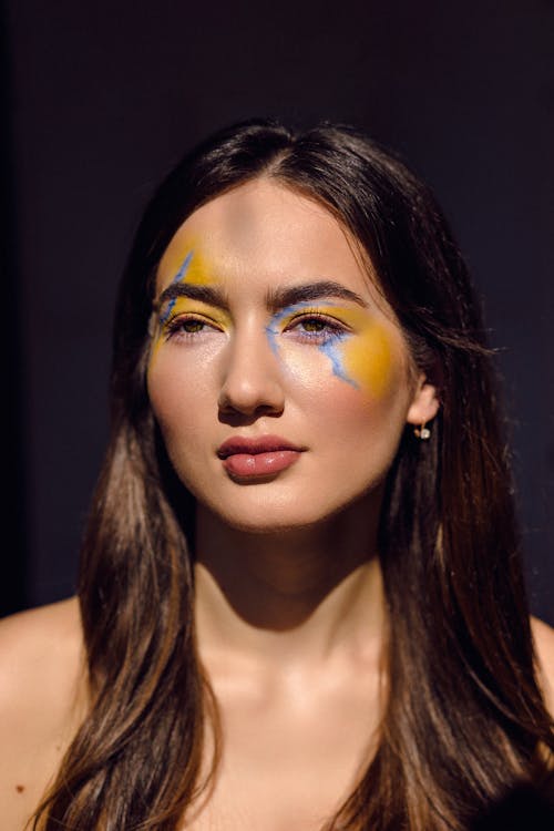 Woman with Yellow and Blue Paint on Face