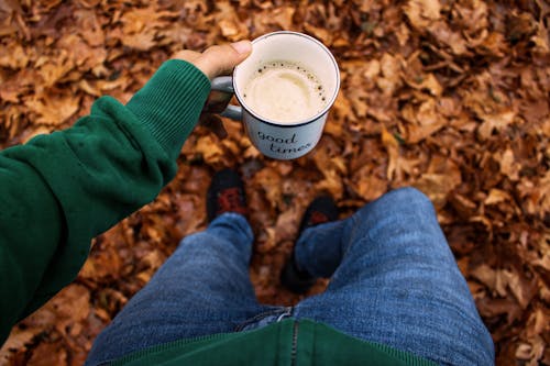 High-Angle Shot of a Person Holding White Mug with Coffee