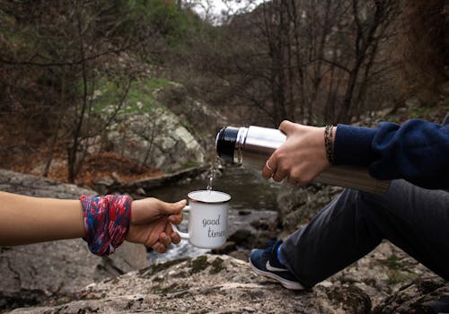 A Person Holding White and Black Cup