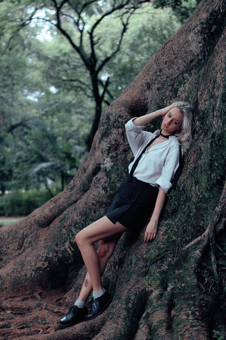 Woman Leaning On Tree