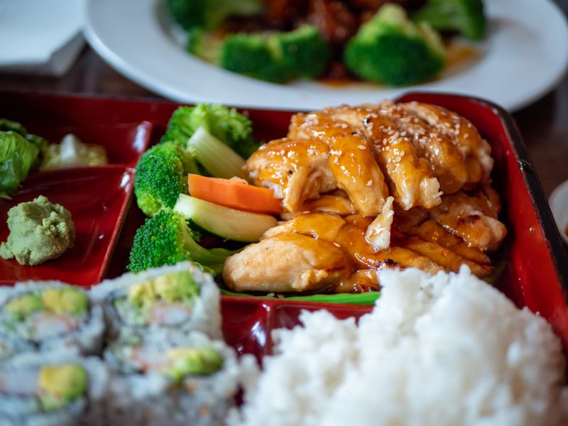 bento box with rice, teriyaki chicken and pickled vegetables