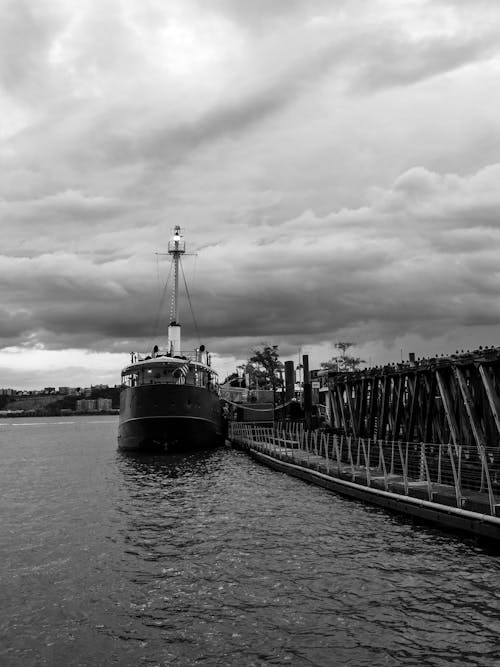 Black and White Photo of Ferry Docked by Pier