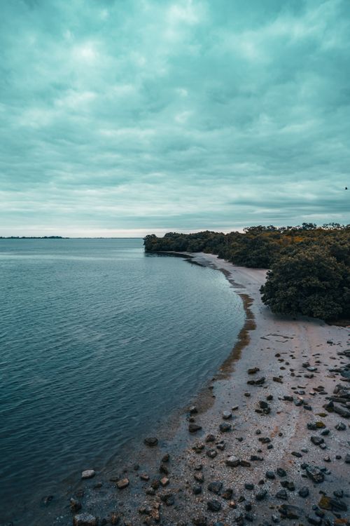 Free A serene aerial view of St. Petersburg coastline with a cloudy sky and tranquil water. Stock Photo