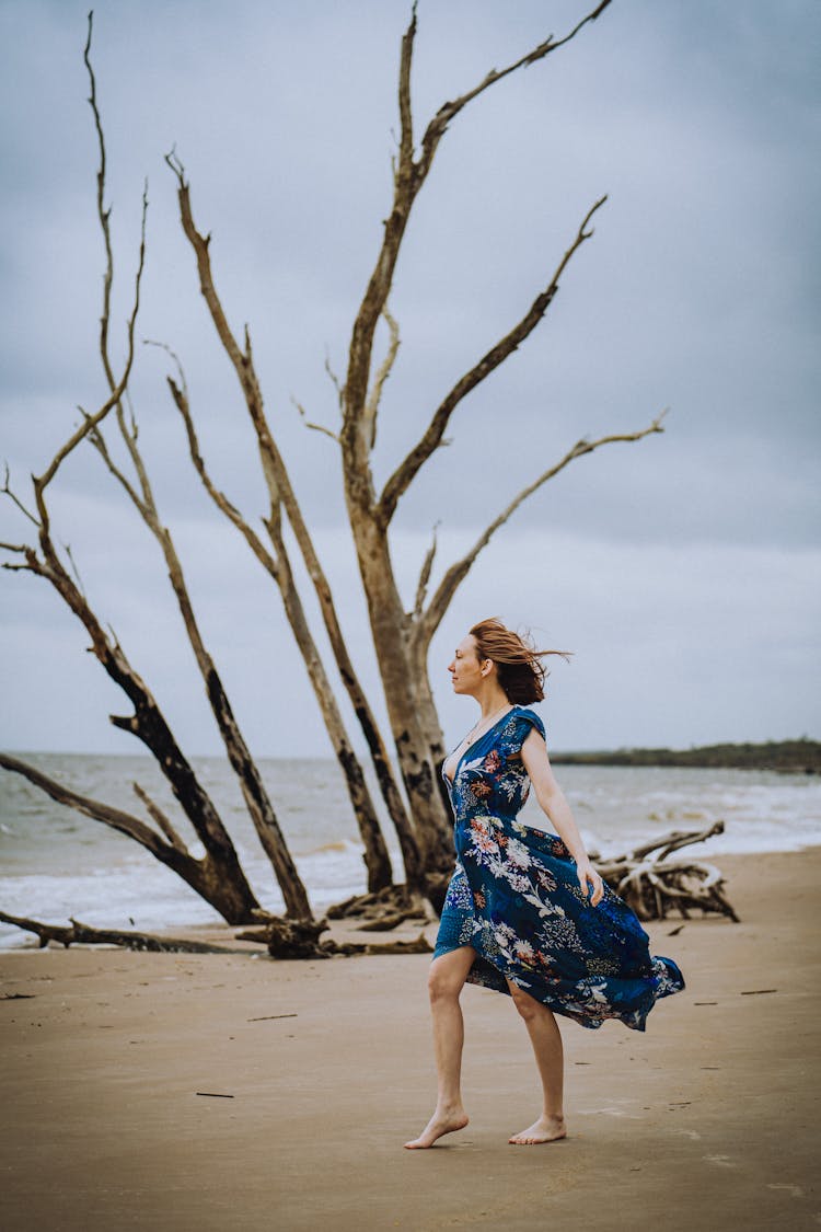 Woman In Dress On Beach