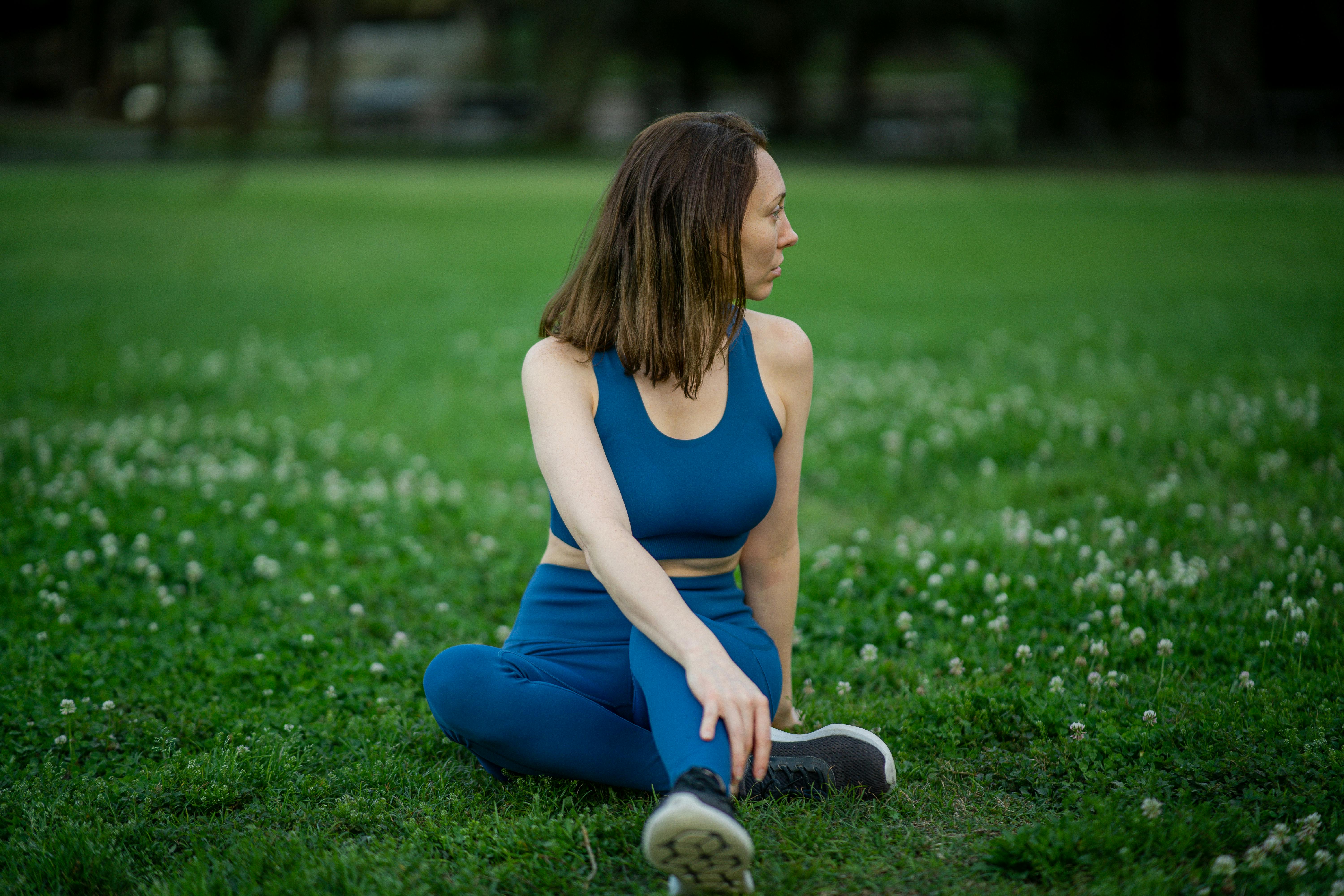 woman stretching on grass