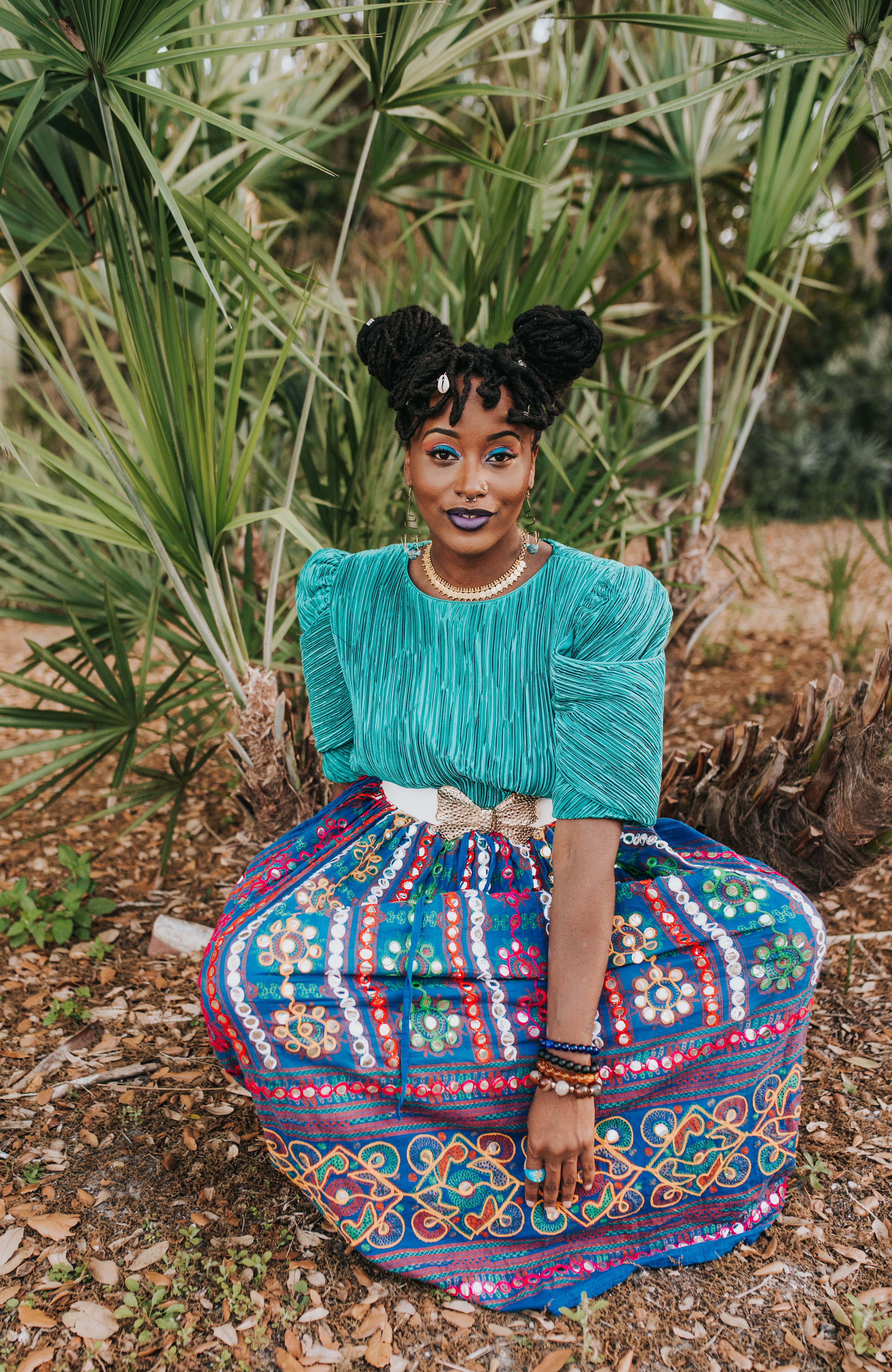 Woman in Traditional Clothing Sitting on Ground · Free Stock Photo