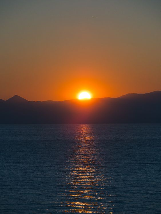 Sun Setting behind Mountains on Lake Shore · Free Stock Photo