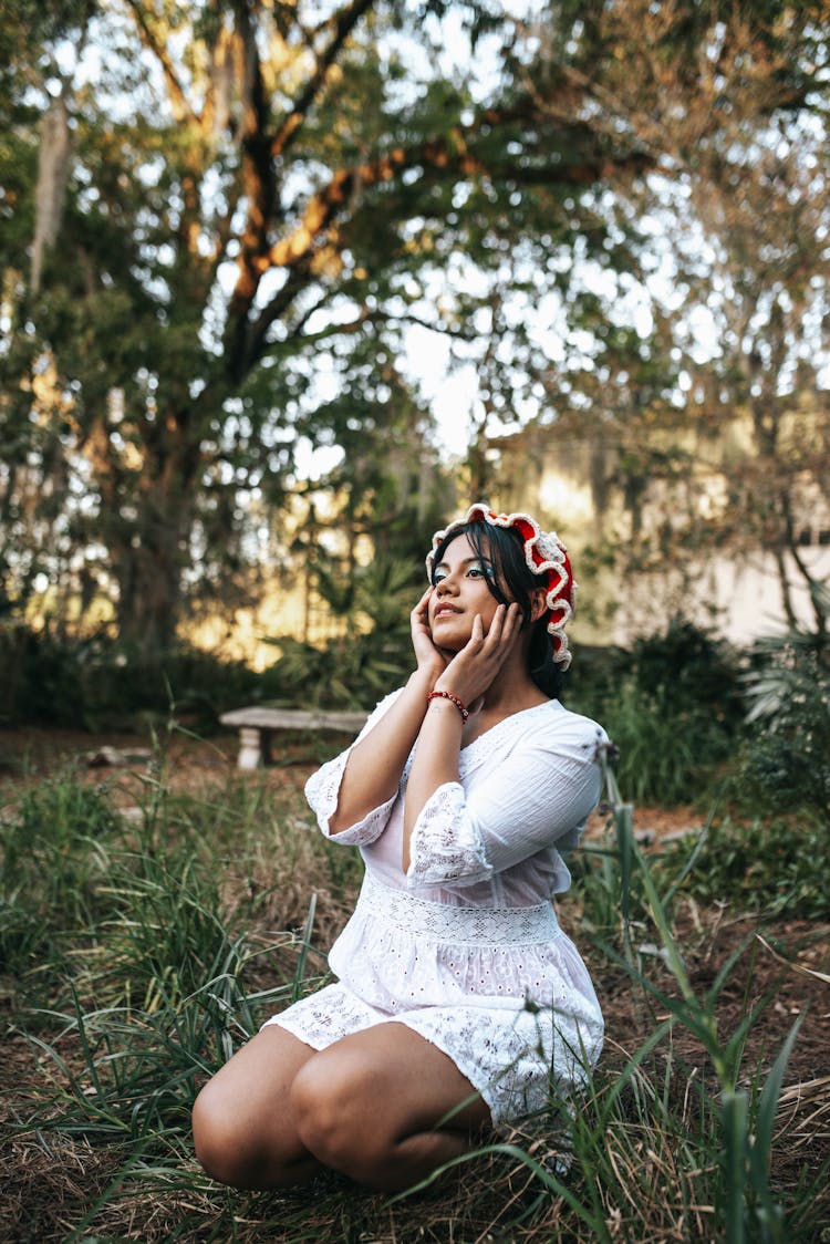 Woman Crouching Near Tree