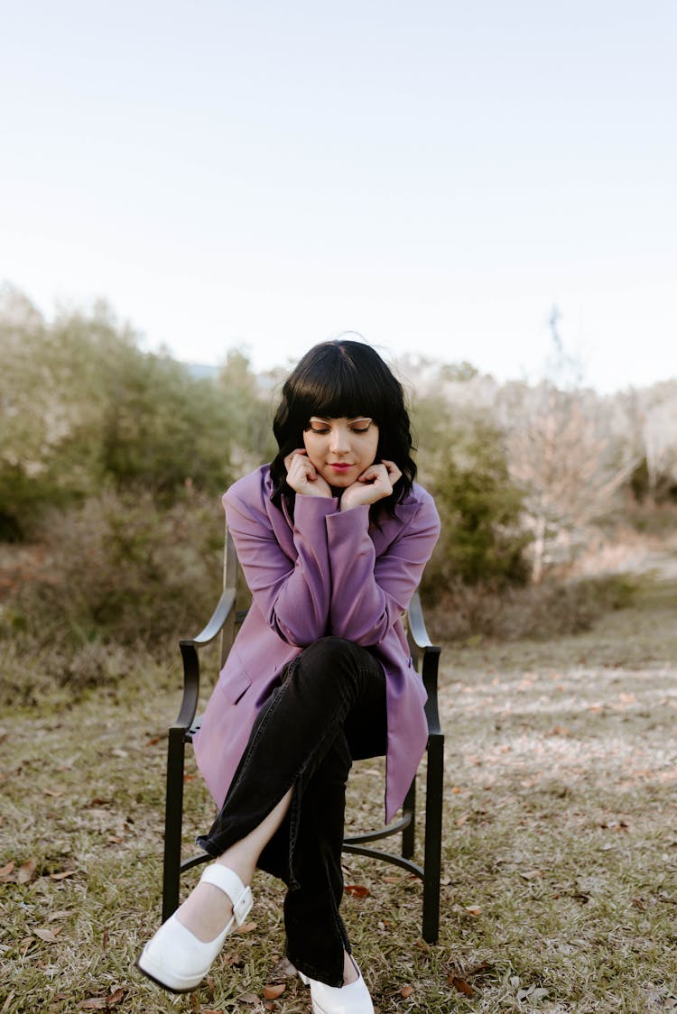 Woman In Coat On Chair