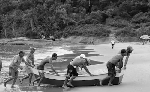 People Pushing a Boat