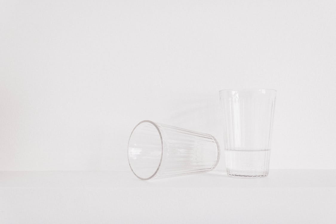 Two Clear Drinking Glasses on Table