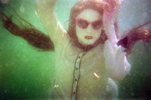 A Woman Wearing Sunglasses Under the Water