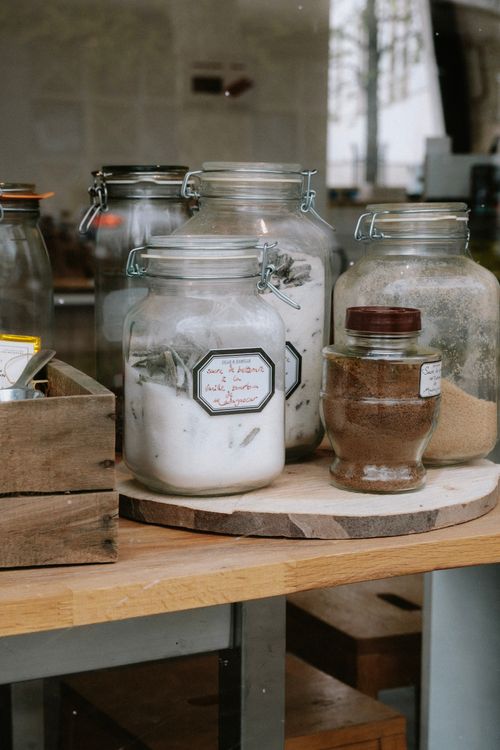 Free Close-up of glass jars with various ingredients on a wooden tray indoors. Stock Photo