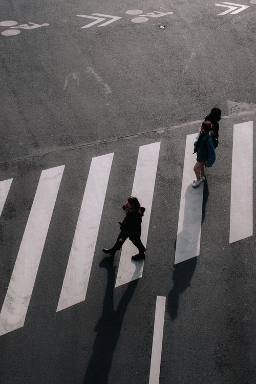 Free Overhead shot capturing pedestrians crossing a zebra crossing. Stock Photo