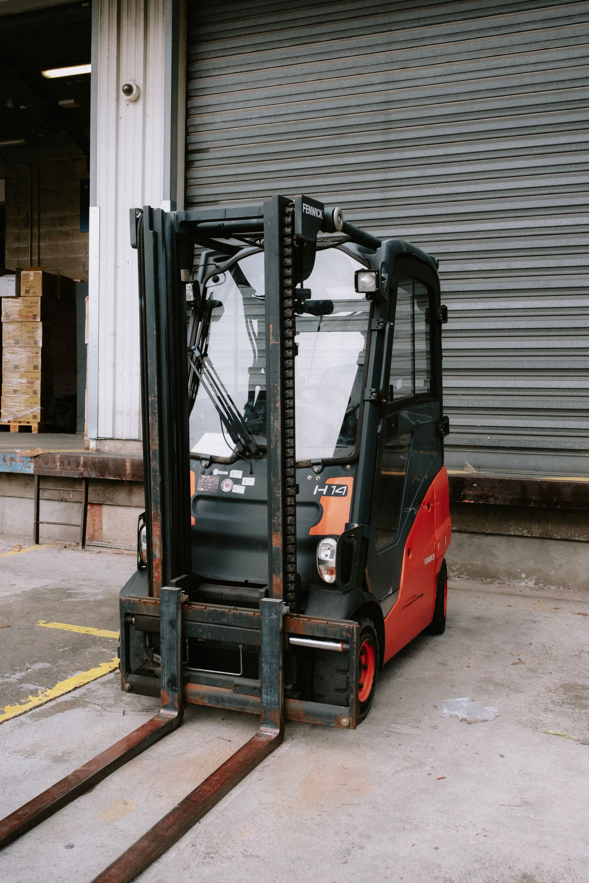 Close-up of a parked forklift in an industrial warehouse dock area