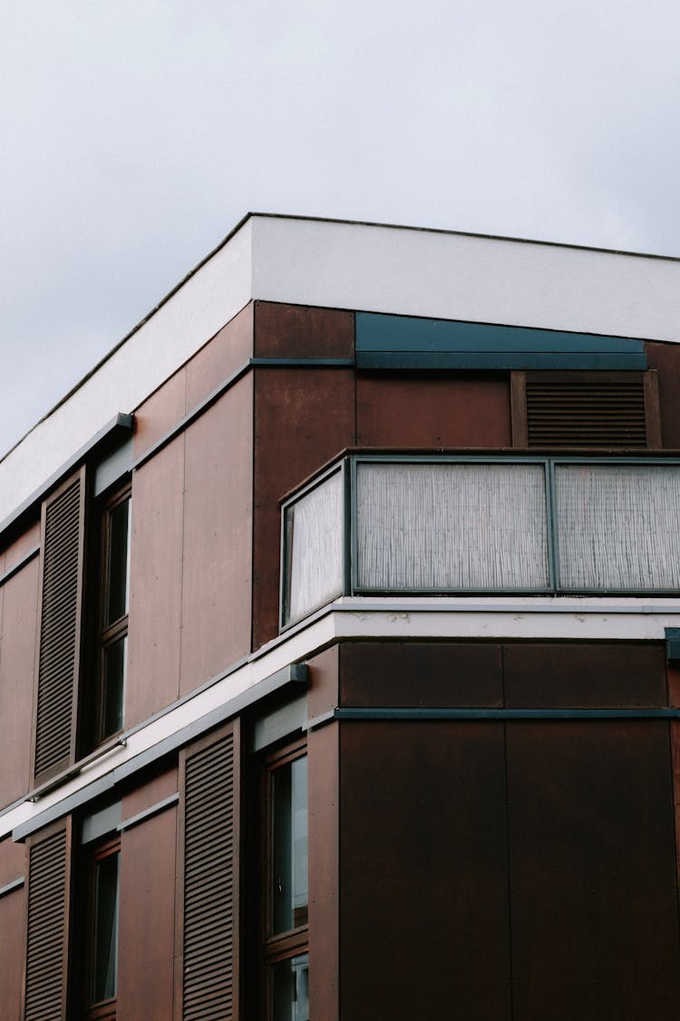 Close-up View Of Apartment Building With Wooden Walls