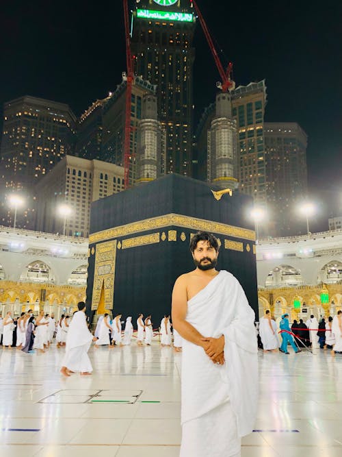 Man in Traditional Clothing at Great Mosque with Kaaba behind