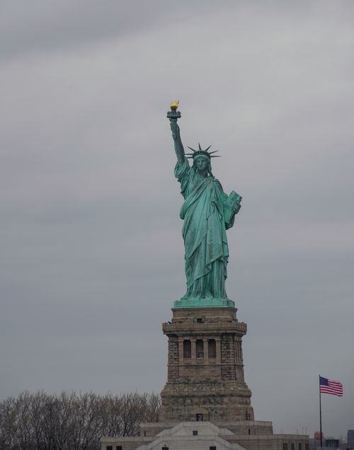 Free Iconic view of the Statue of Liberty with an overcast sky in New York City. Stock Photo