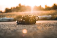 Brown and Black Car Toy on Gray Sand during Sunset
