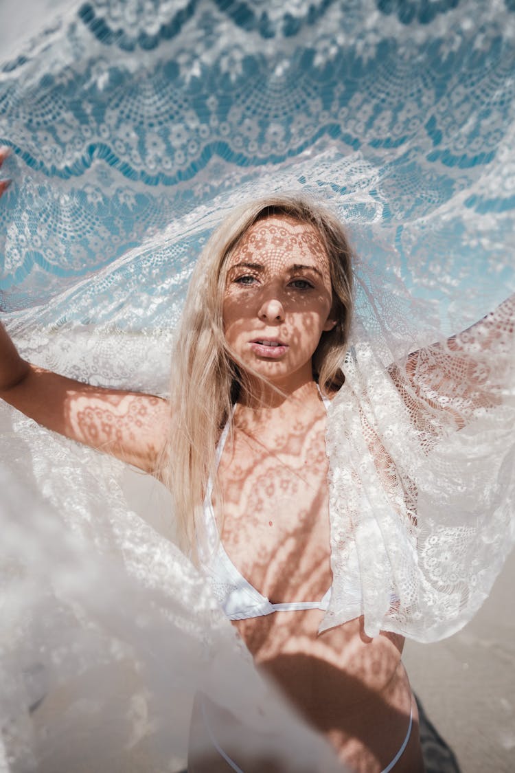 Woman In White Bikini Holding A Lace Fabric