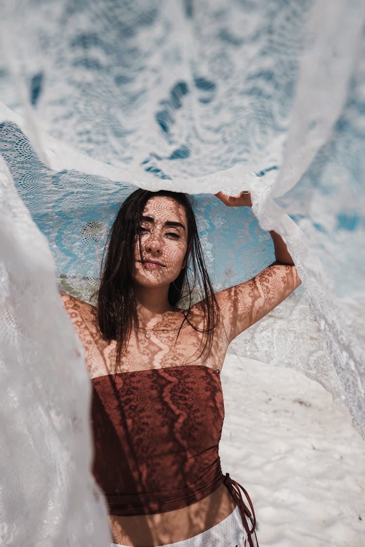 Woman Posing And Holding Fabric Over Head