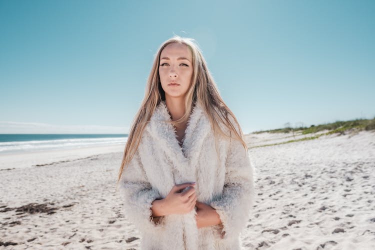 Woman Wearing Coat On Beach 