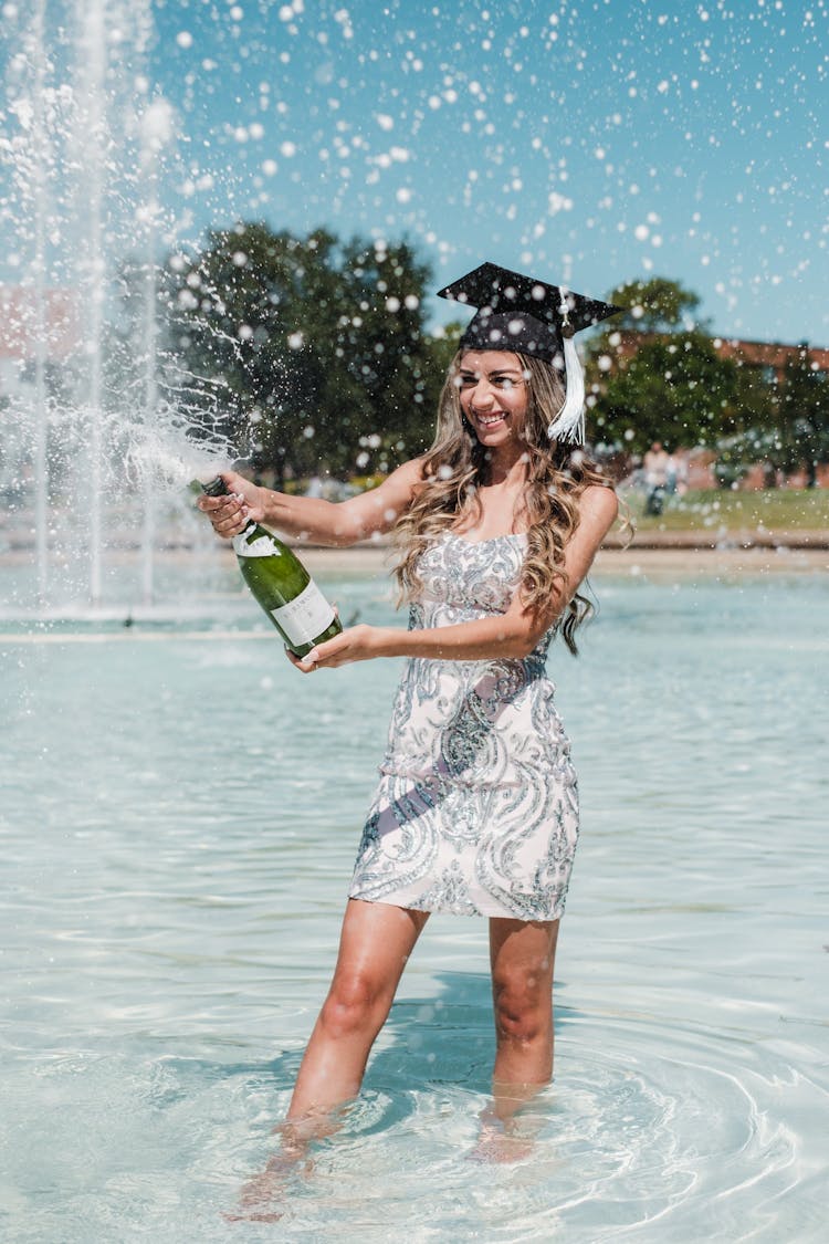 Woman With Champagne In Fountain