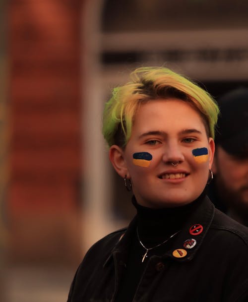 Close-up Photo of Young Woman with Face Paint 