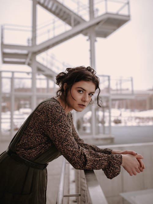 Woman Leaning Against Railing