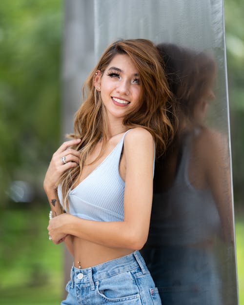 A Woman in White Tank Top and Blue Denim Shorts