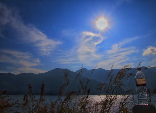 Sunshine with water bottle phewa lake pokhara, nepal 
