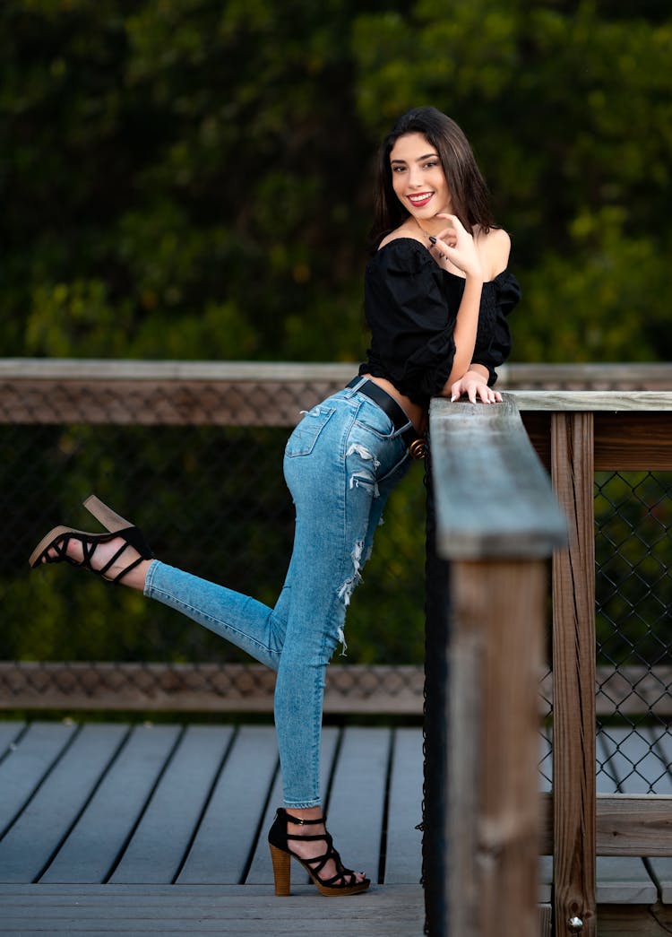 Woman Posing By Wooden Barrier