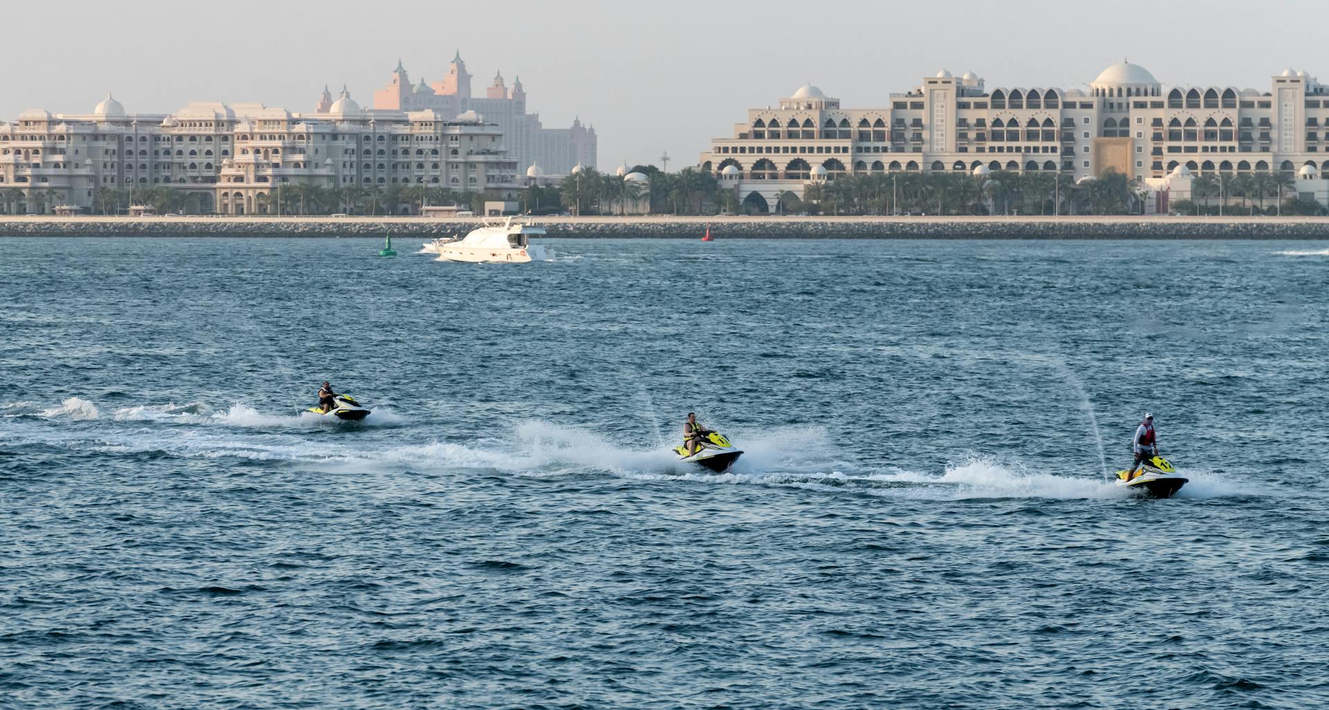 Exciting jet ski ride in Dubai with iconic skyline and sea backdrop, capturing urban adventure and water sports.