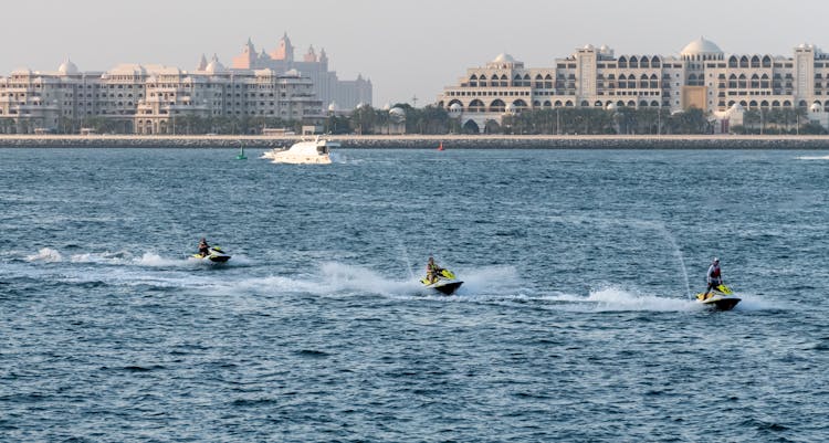 People Riding Jet Skis On Sea