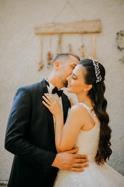 Man in Black Suit Kissin a Woman