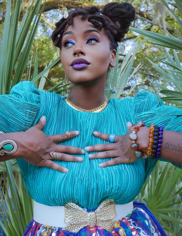 Woman Posing In Blue Outfit And Blue Makeup