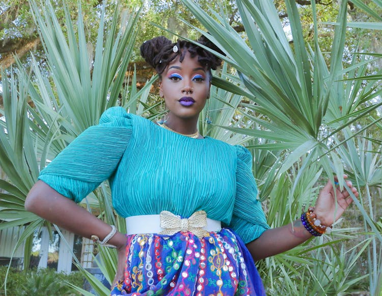 Woman Posing In Blue Outfit And Blue Makeup