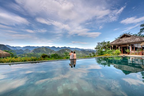 Tourists Sitting on the Poolside while Looking at the Beautiful Scenery