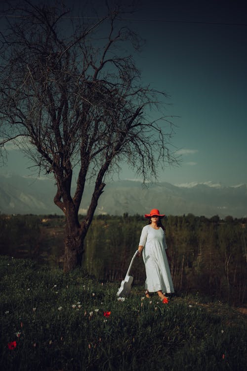 A Woman Wearing White Dress and Red Hat 