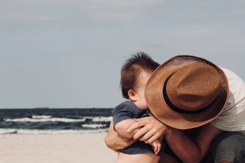 A Father Hugging his Baby on the Beach