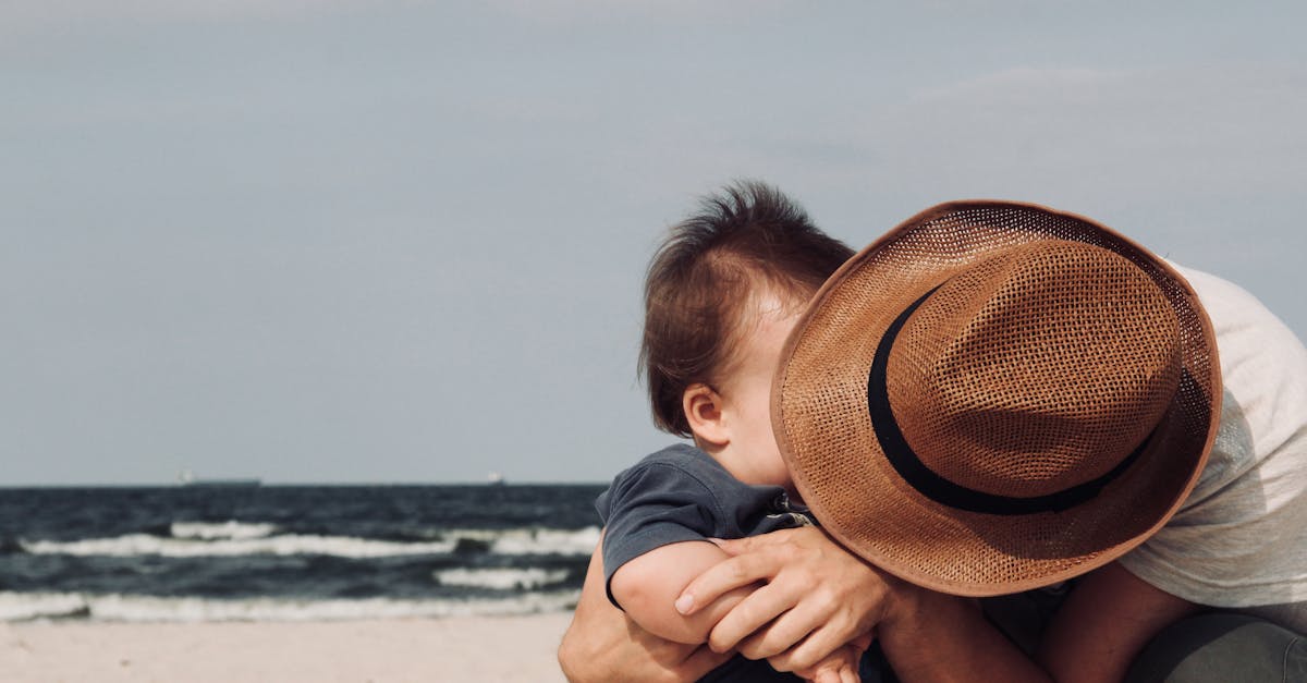 Photo of Person Holding His Baby