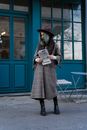 Woman in Black Coat Holding Book