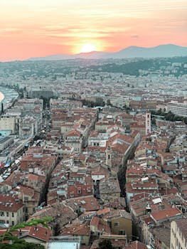 A breathtaking aerial view of Nice, France at sunset, capturing the city's historic charm and vibrant skyline.
