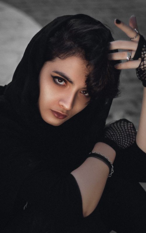 Free Dramatic close-up portrait of a woman in black attire, embracing edgy style with bold makeup. Stock Photo