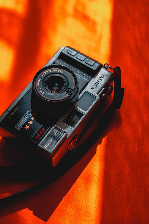 Free Black Analog Camera on an Orange Surface Stock Photo