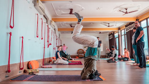 Participants practicing yoga in a Rishikesh studio, showcasing flexibility and wellbeing.