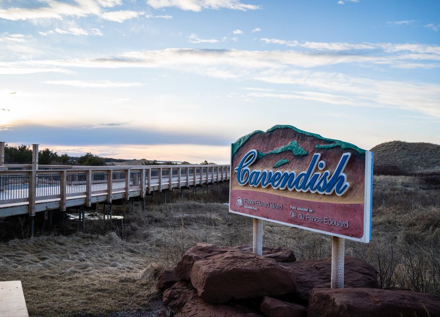 Cavendish sign by boardwalk under blue skies in Prince Edward Island, Canada.