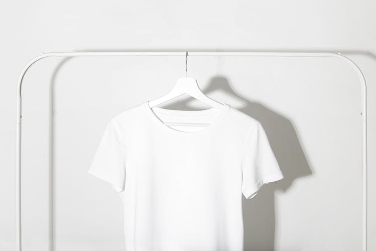 White T-Shirt Hanging On A Rack 